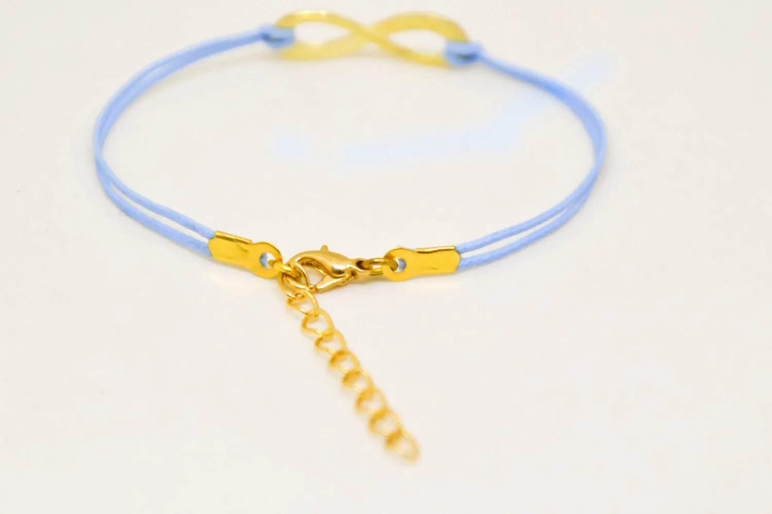 Blue cord bracelet with a gold tone infinity endless charm, handmade mothers day gift, preppy jewelry