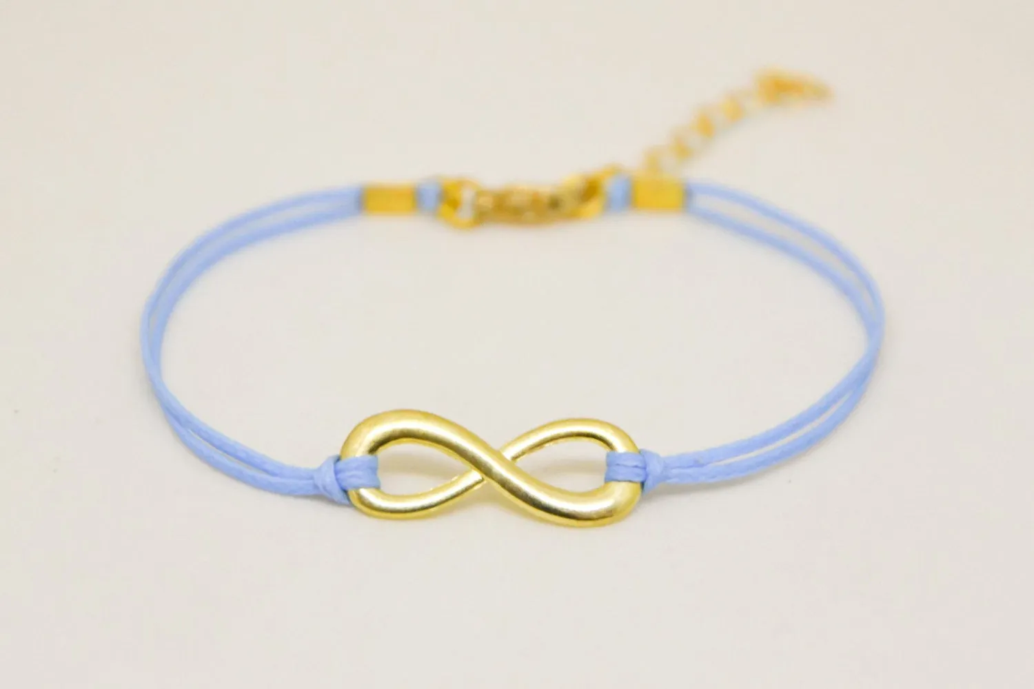 Blue cord bracelet with a gold tone infinity endless charm, handmade mothers day gift, preppy jewelry