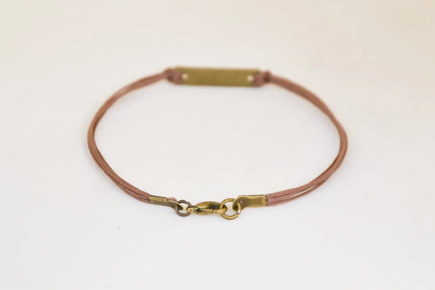 Bronze tone Courage bracelet for men, brown cord