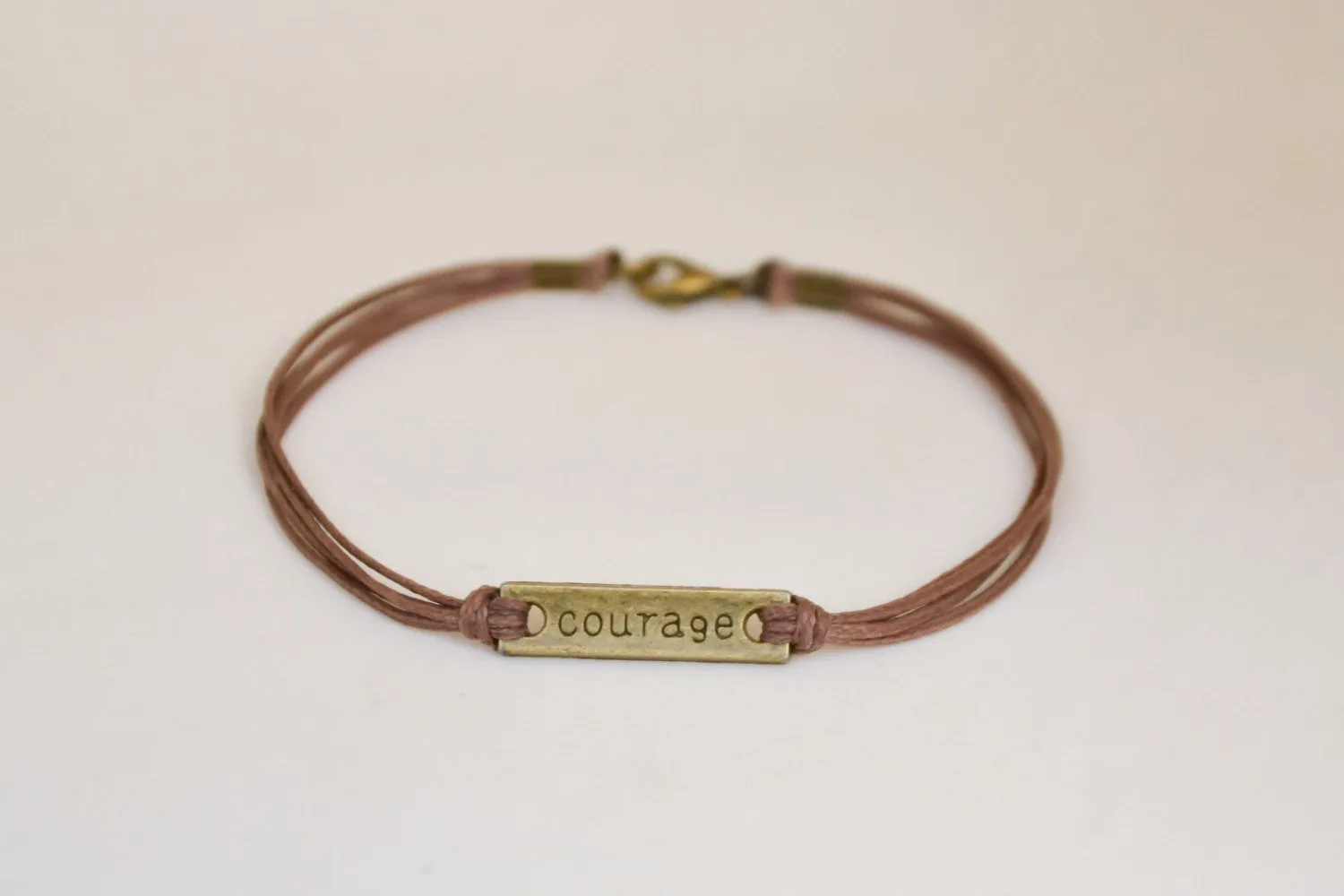 Bronze tone Courage bracelet for men, brown cord